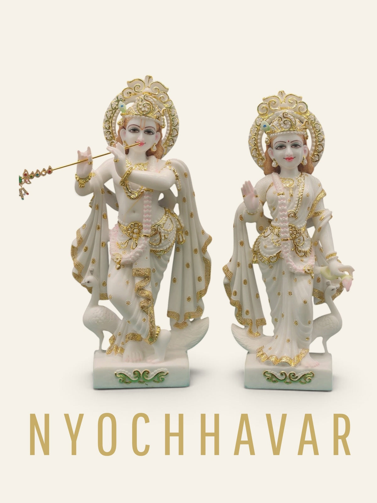 White marble Radha Krishna statue pair with gold detailing, carved halos and peacocks at the base